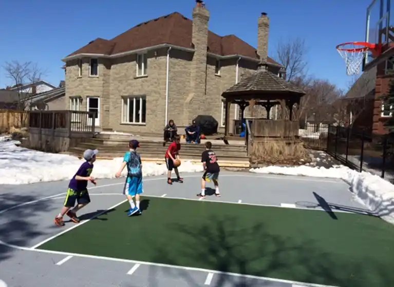 Kids playing basketball on their Backyard Court, Waterloo, ON